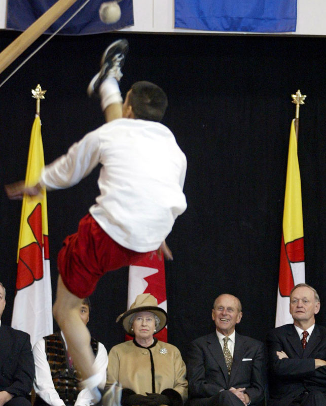 Queen Elizabeth II, Prince Philip and then-prime minister Jean Chretien take in a high kick demonstration during the Royals' 2002 visit to Iqaluit. Photo Jonathan Hayward/CP Images