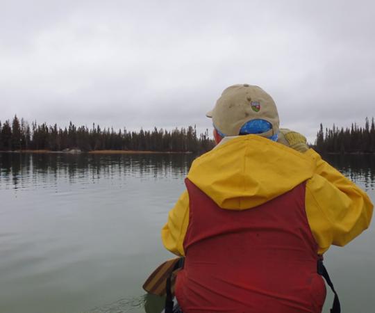 Paddling out to secret weekend camping spots at Hidden Lake, NWT. Photo by Tim Edwards