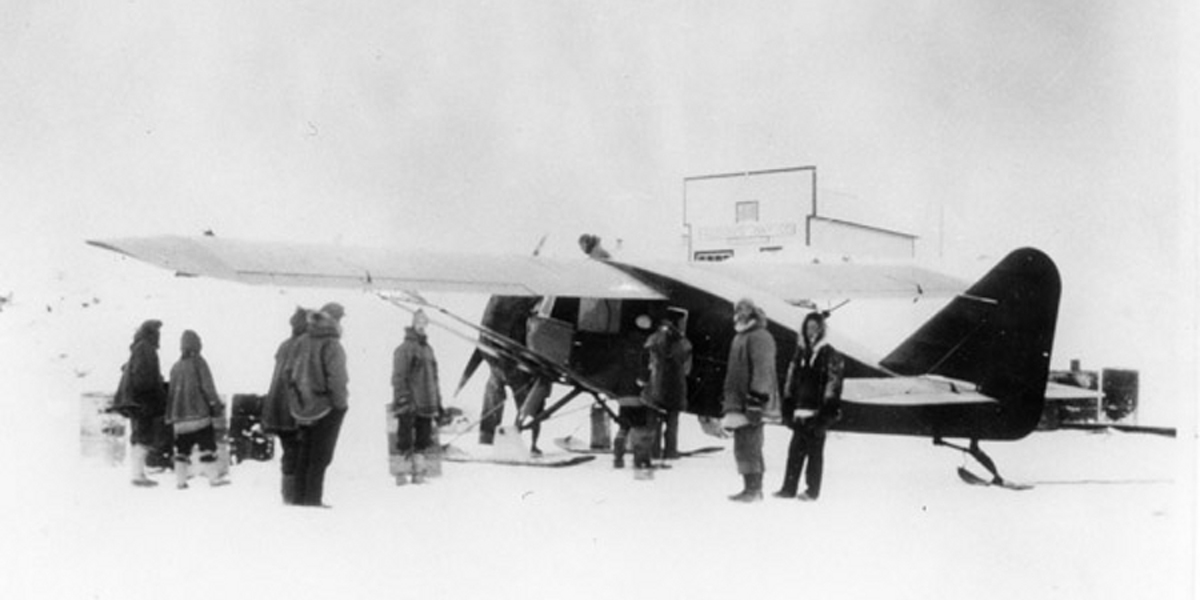 Wop May loading his airplane in Aklavik, NWT, during the hunt for the Mad Trapper in 1932. Public Domain