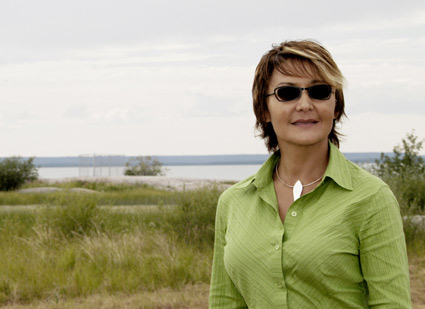 Suzan Marie stands on the shore near Behchoko