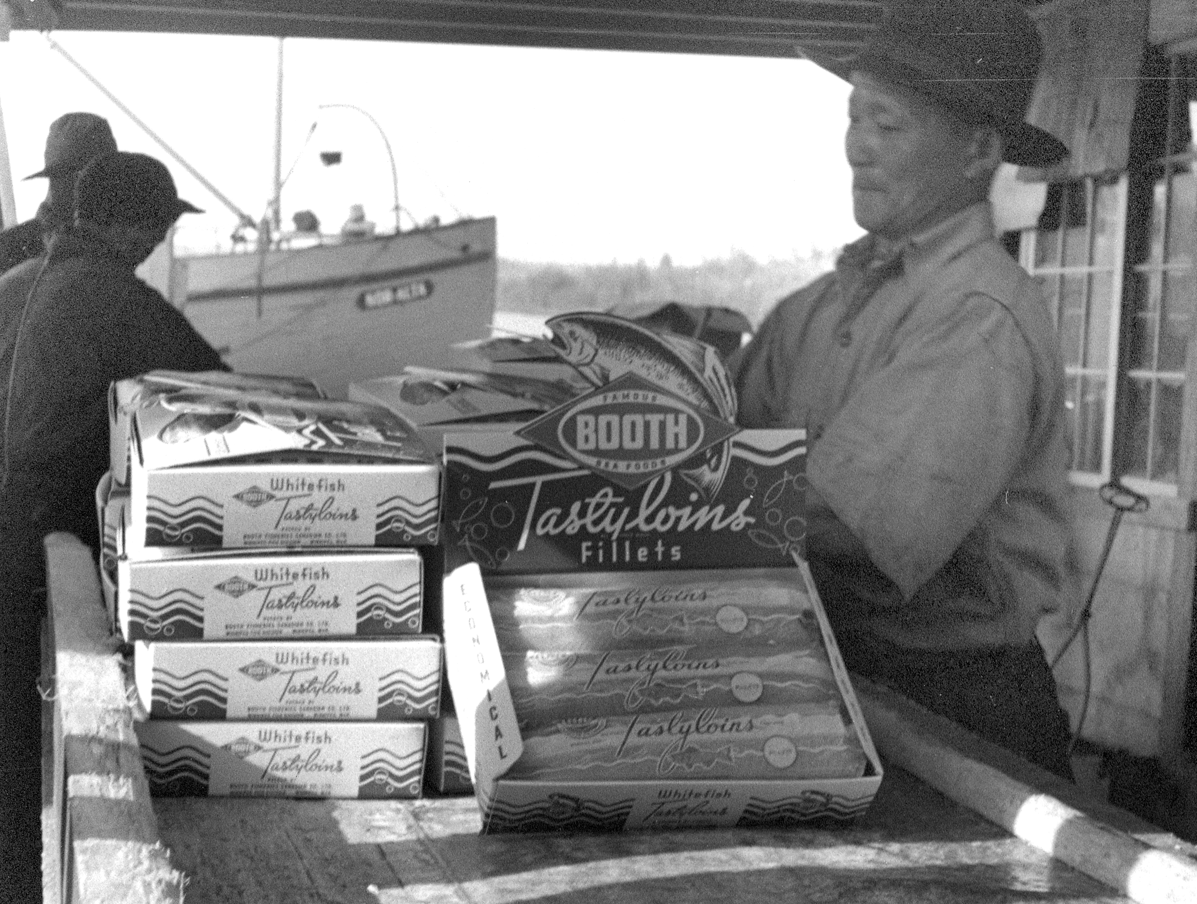 A Japanese worker packs frozen whitefish filets at Gros Cap in 1946.