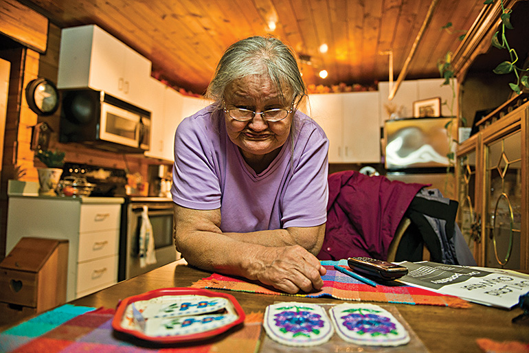 Cece Baton, one of Délı¸ne’s most productive crafters, shows off her uppers. Photo by Angela Gzowski