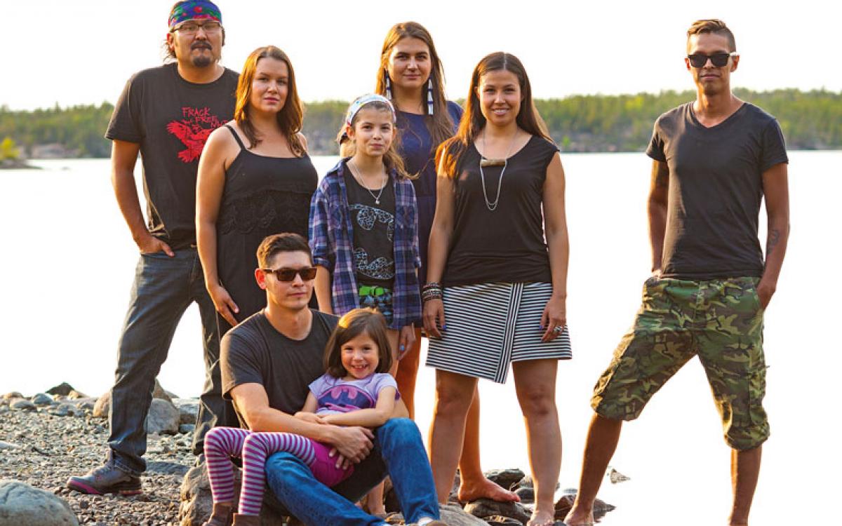 Left to right: Dëneze Nakehk'o, Nina Larsson, Maslyn Scott, Tania Larsson, Kyla Kakfwi Scott, Eugene Boulanger. In front: Amos Scott with Sadeya Scott. Photo: Hannah Eden/Up Here