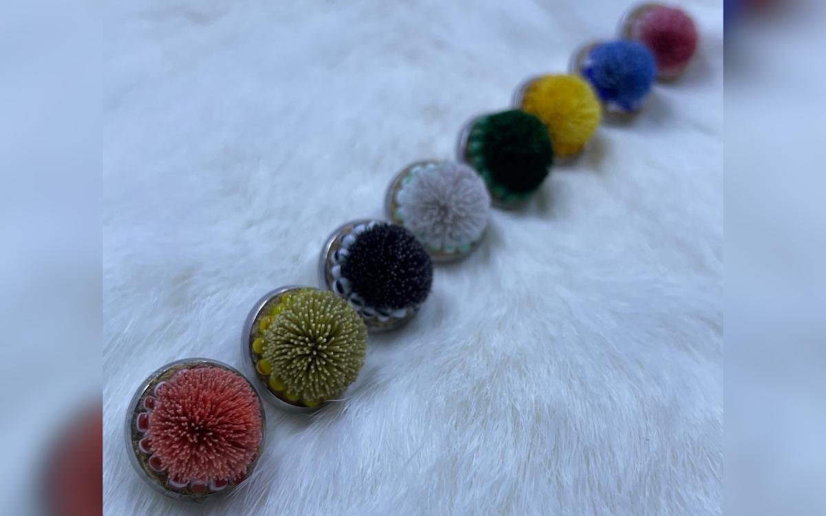 A line of colourful tufted earrings made by Alyssa Ross