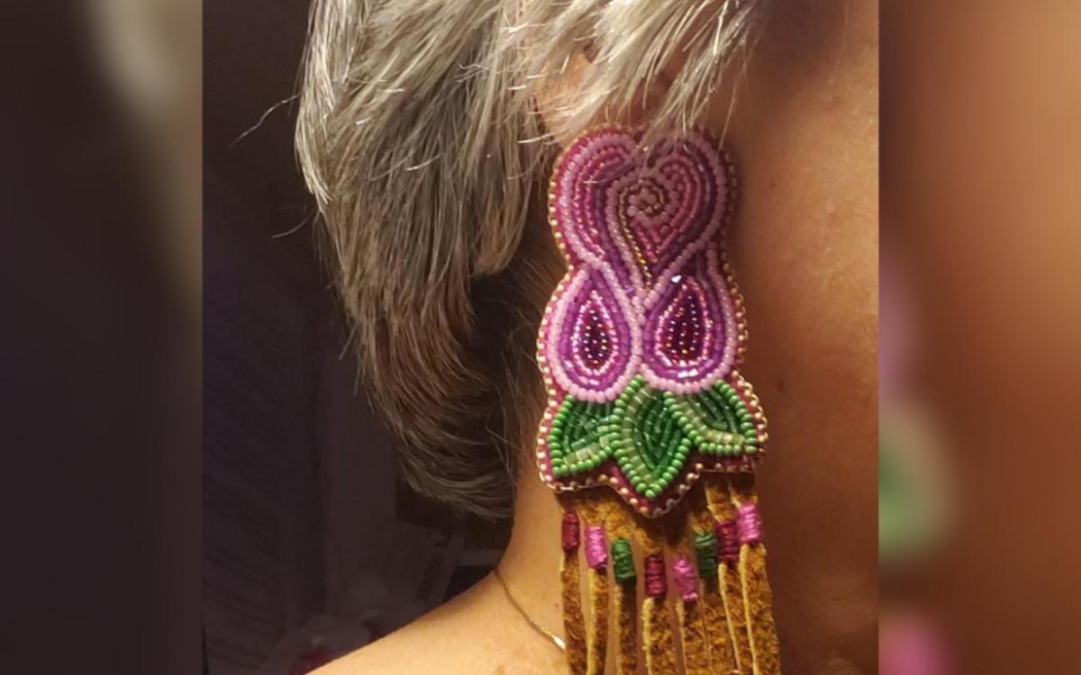 A model shows off a pair of earrings from Sharon Vittrekwa