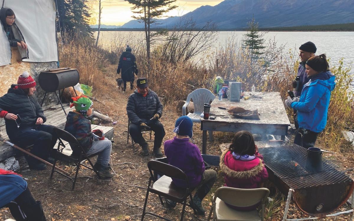 Elder David Johnny Sr. teaching Beaver Creek’s students to use a type of tree root to make rope.