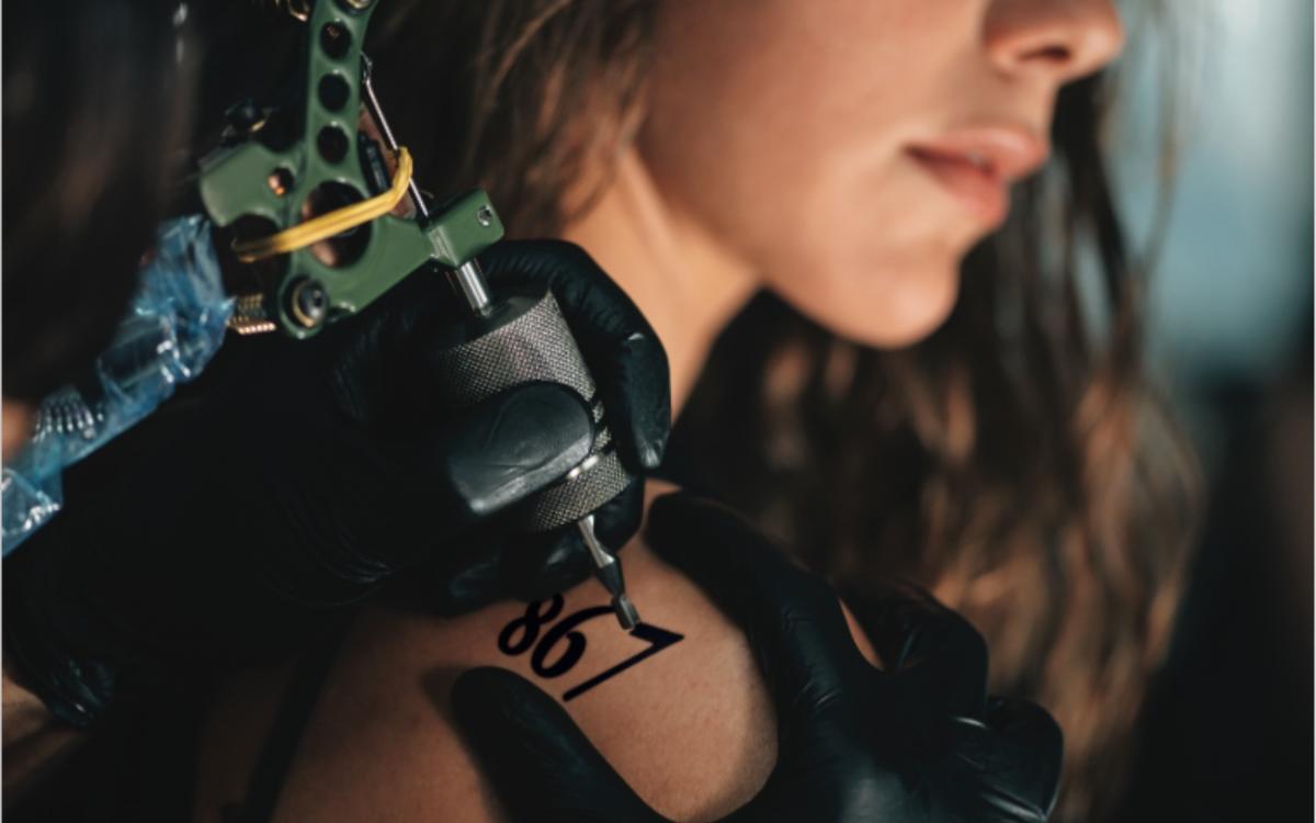 A woman gets "867" tattooed on her shoulder