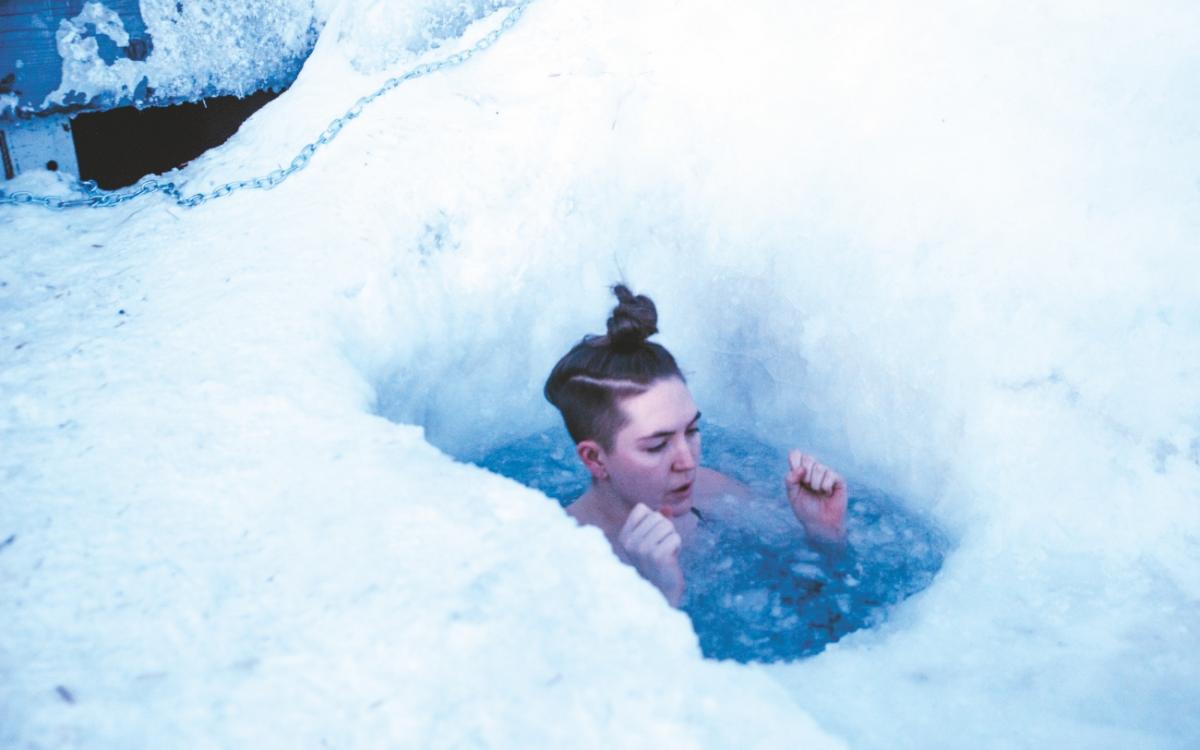 Cat McGurk braces herself as she wades through the frozen water.