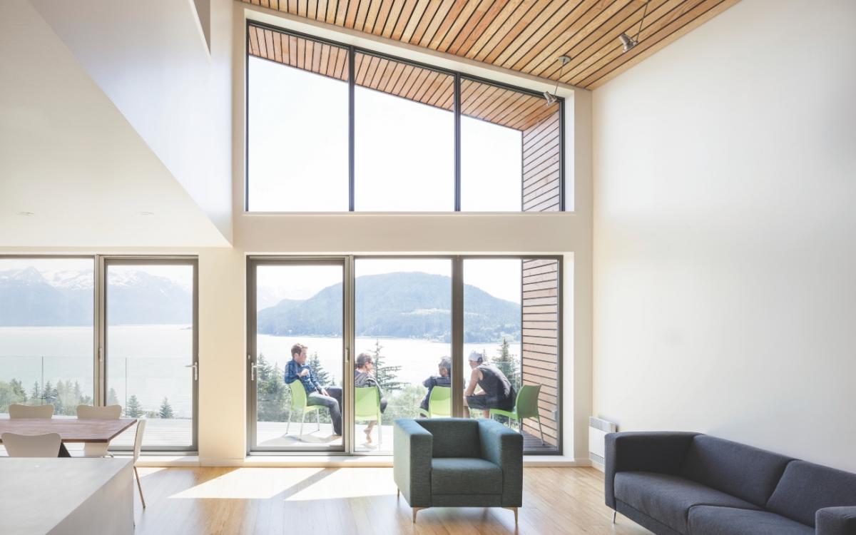 Wide windows overlook mountain views in this dream home