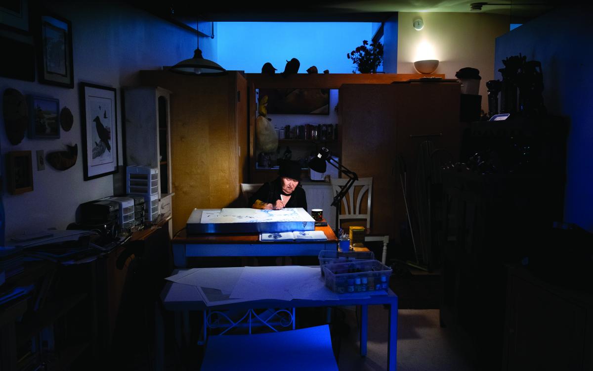 Inuk master artist Germaine Arnaktauyok, working on a piece in her home