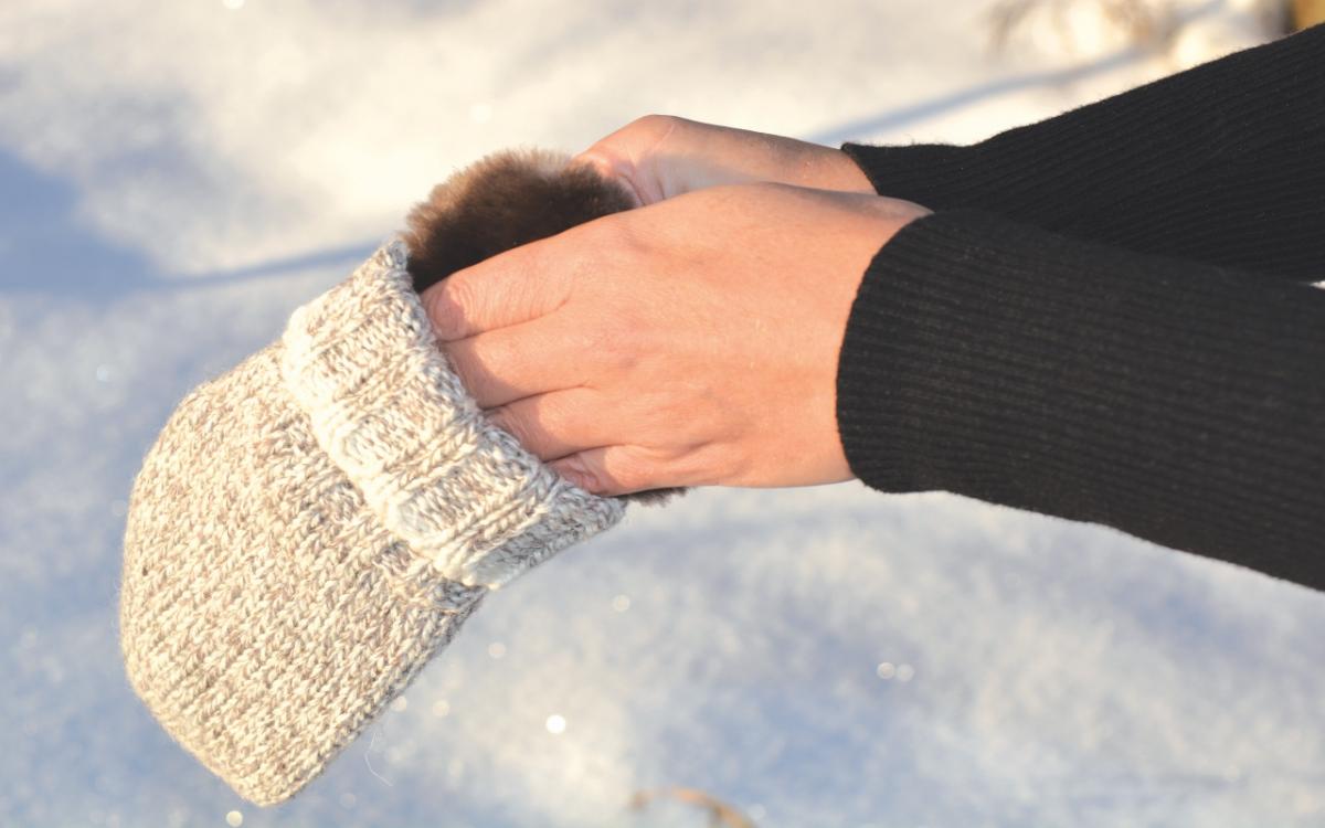 Model puts hand warmer inside mitt