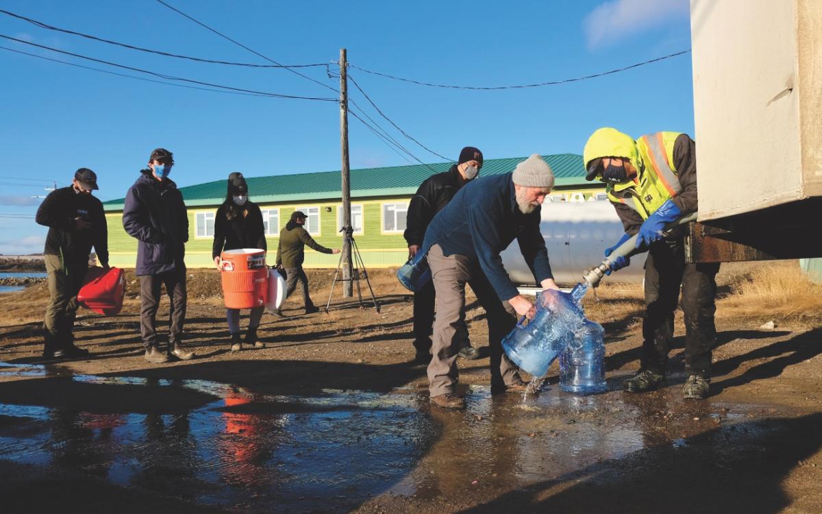 Iqaluit residents filling up water buckets.