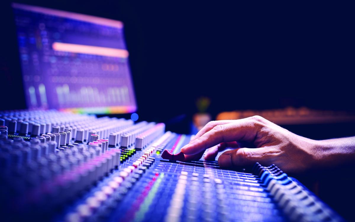 Hand using a sound board.