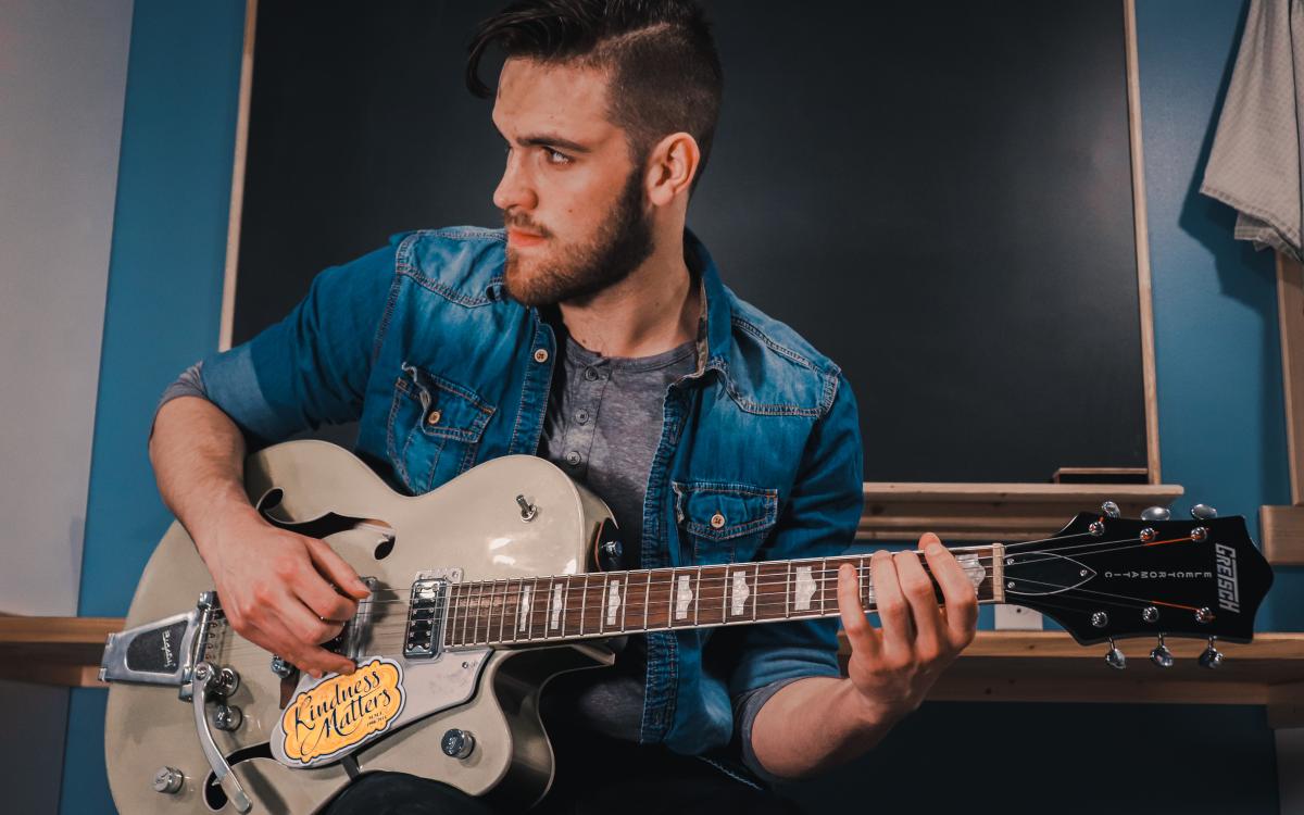 Elijah Bekk playing his guitar