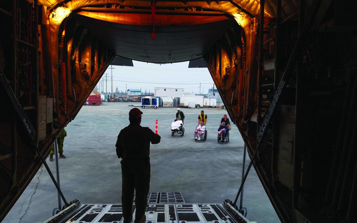 AVENS RESIDENTS ARE BROUGHT OUT TO THEIR HERCULES ON ON THE NIGHT OF THEIR EVACUATION.