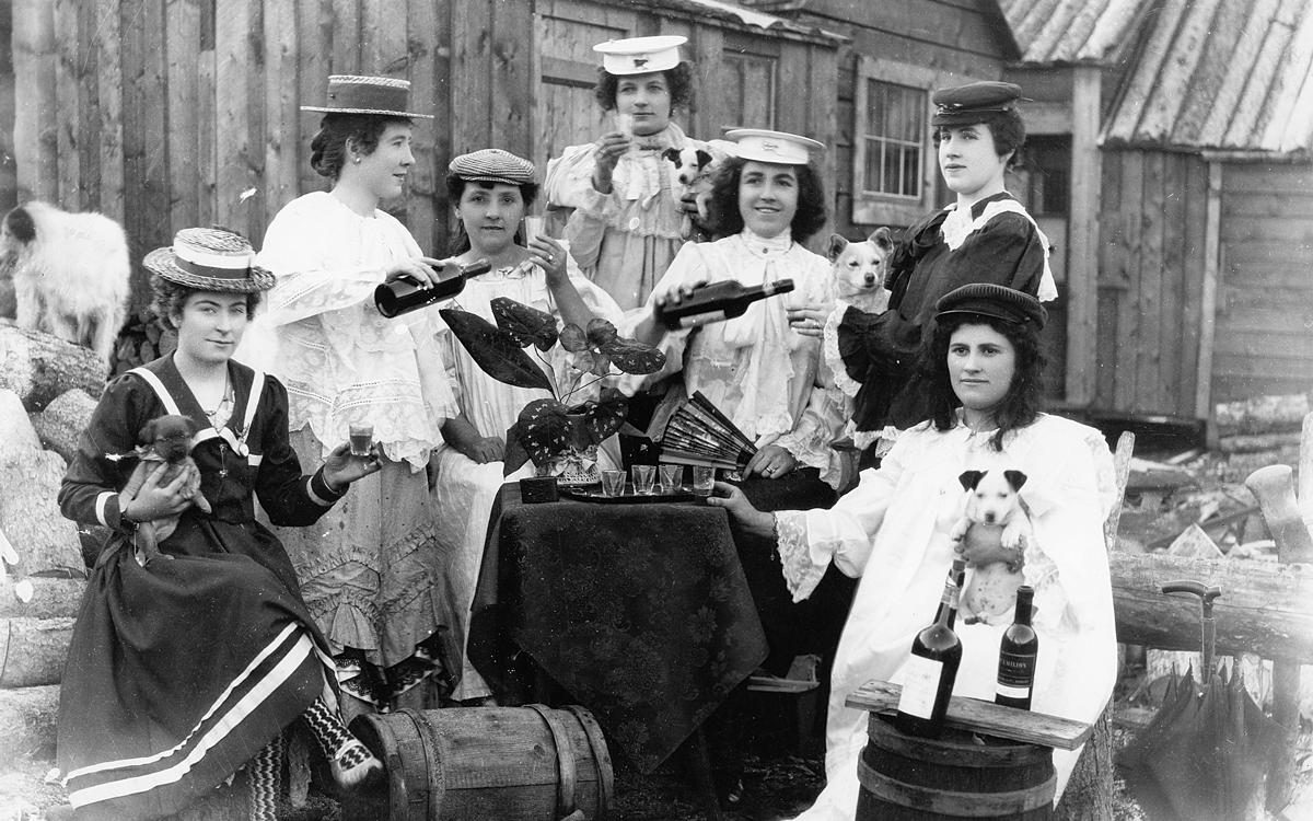 Long before the U.S. temperance movement put a cork in Klondike liquor, Yukoners loved their 'hooch.' Here, Dawson ladies hold a 'drinking bee' in 1900. Joseph Duclos/Dawson City Museum