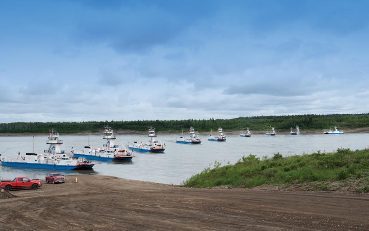 The MV Lafferty, captained by Graham Cox, battles the Liard River current in the Deh Cho. Photo: Herb Mathisen/Up Here, Photo illustration: Beth Covvey