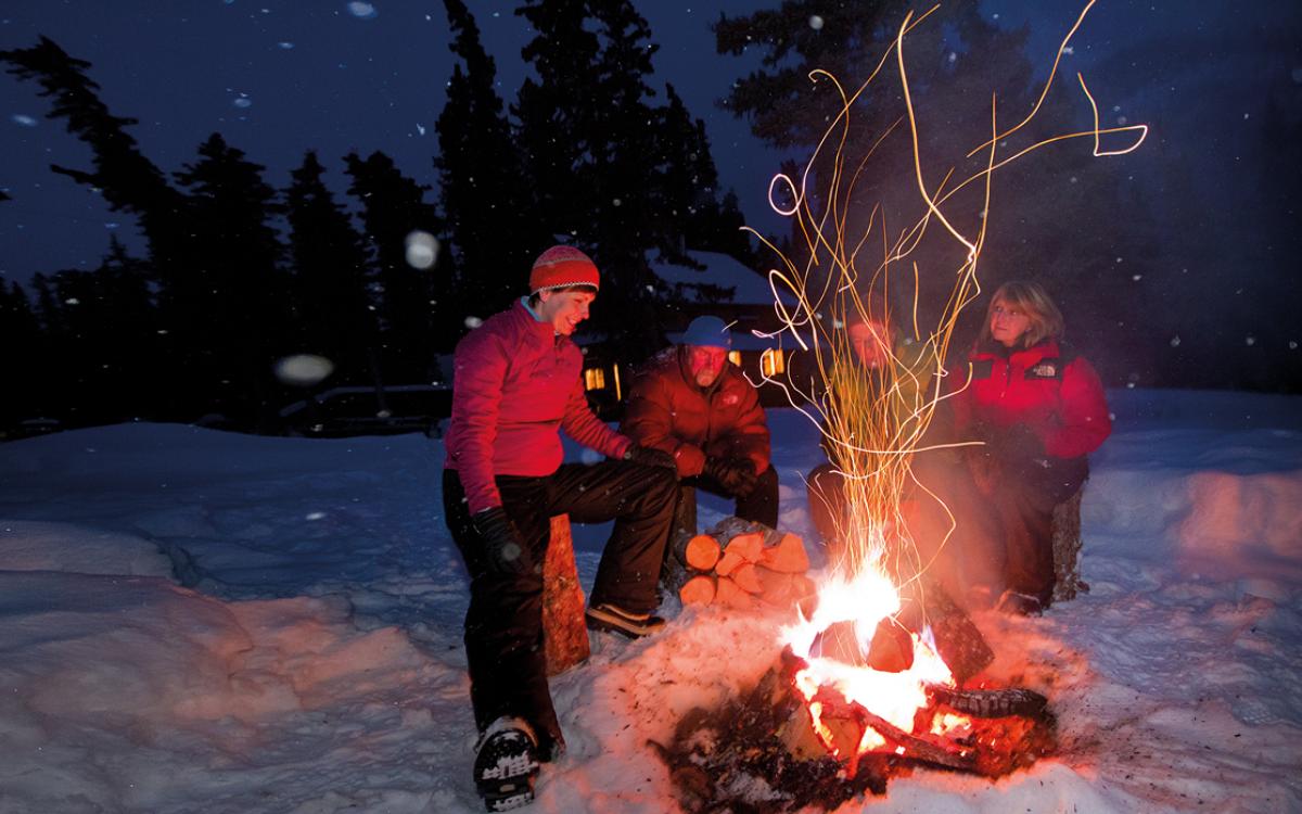 Cabin-dwellers around the fire. Photo courtesy of Fritz Mueller/Government of Yukon