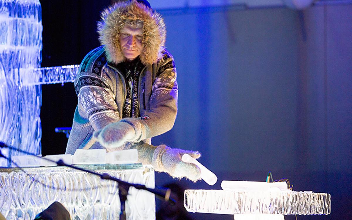 Terje Isungset tests the ice by drumming it with his fingers.