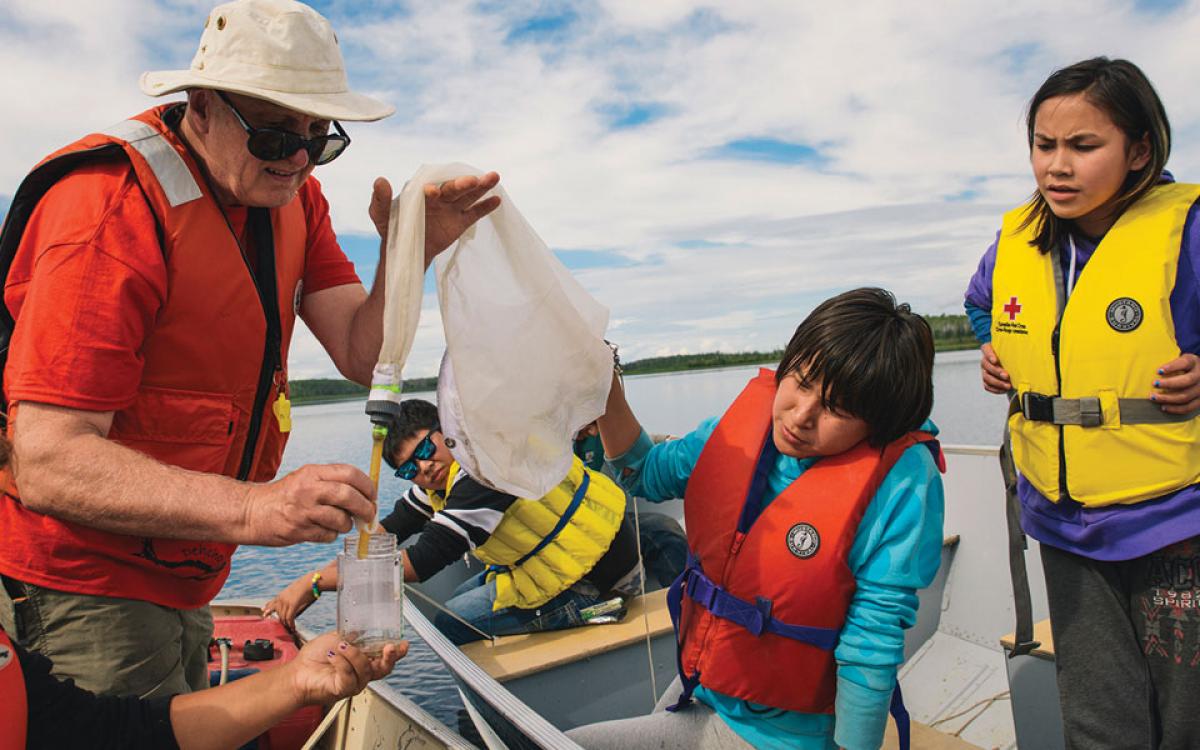 TESTING THE WATERS: Students learn how to check what's in their water, out in a boat on the Mackenzie River. Photo by Patrick Kane