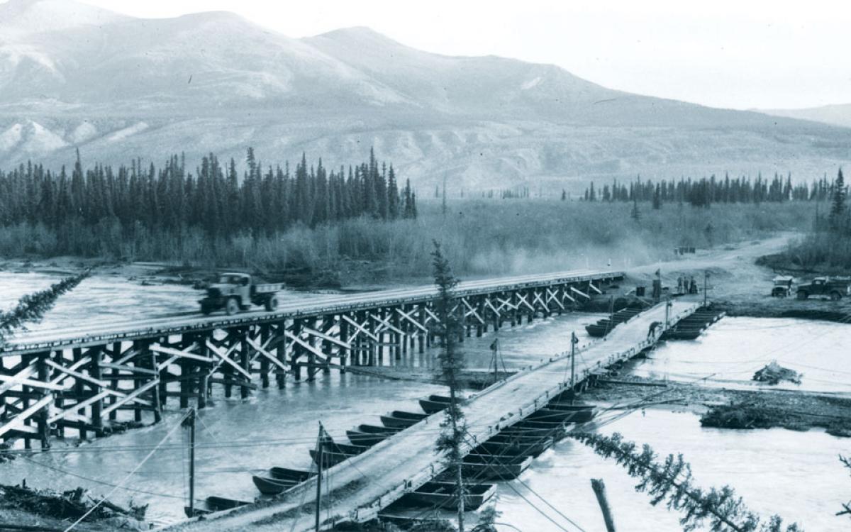 Permanent wood piles replace a temporary pontoon bridge on the Alaska Highway. Photo courtesy of Yukon Archives, R.A. Cartter fonds #1498