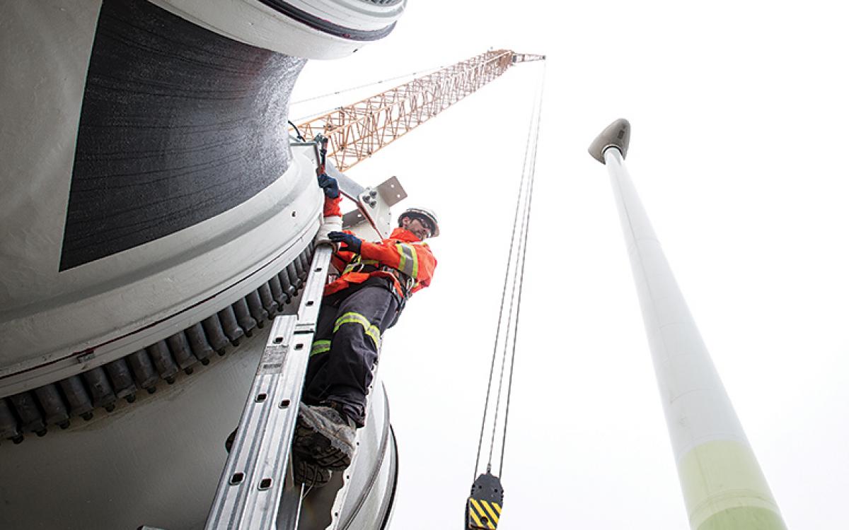 Workers erect one of the four 2.3-megawatt turbines now churning out energy at the Diavik diamond mine in the NWT. Photo courtesy of Rio Tinto (DDM)