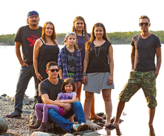 Left to right: Dëneze Nakehk'o, Nina Larsson, Maslyn Scott, Tania Larsson, Kyla Kakfwi Scott, Eugene Boulanger. In front: Amos Scott with Sadeya Scott. Photo: Hannah Eden/Up Here