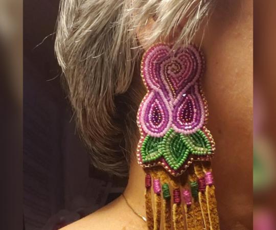 A model shows off a pair of earrings from Sharon Vittrekwa