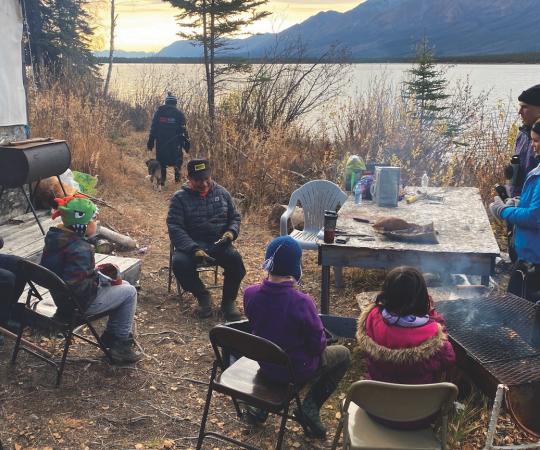 Elder David Johnny Sr. teaching Beaver Creek’s students to use a type of tree root to make rope.