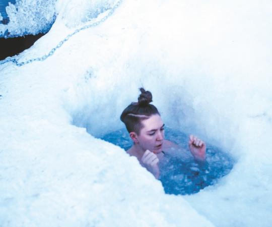 Cat McGurk braces herself as she wades through the frozen water.