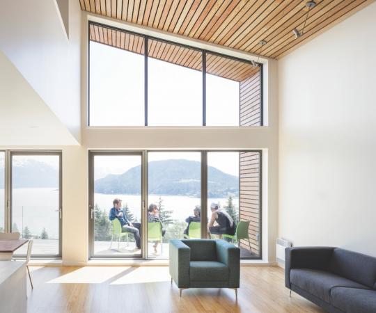 Wide windows overlook mountain views in this dream home