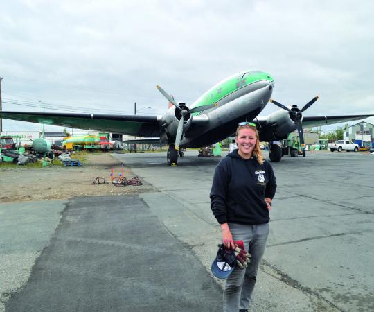 Jamie MacDonald stands in from of a Buffalo plane