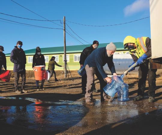 Iqaluit residents filling up water buckets.