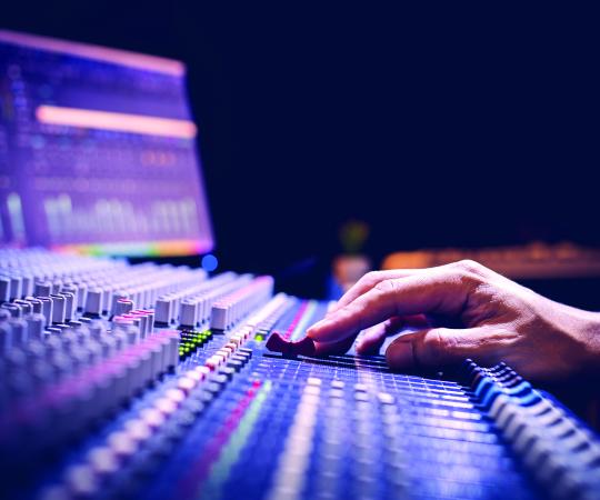 Hand using a sound board.