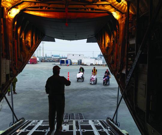AVENS RESIDENTS ARE BROUGHT OUT TO THEIR HERCULES ON ON THE NIGHT OF THEIR EVACUATION.