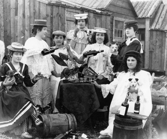 Long before the U.S. temperance movement put a cork in Klondike liquor, Yukoners loved their 'hooch.' Here, Dawson ladies hold a 'drinking bee' in 1900. Joseph Duclos/Dawson City Museum