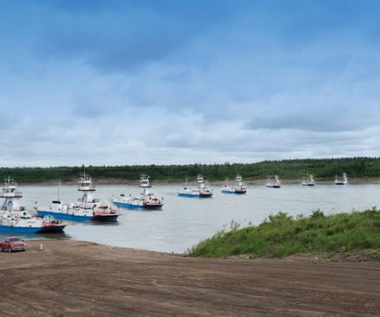 The MV Lafferty, captained by Graham Cox, battles the Liard River current in the Deh Cho. Photo: Herb Mathisen/Up Here, Photo illustration: Beth Covvey