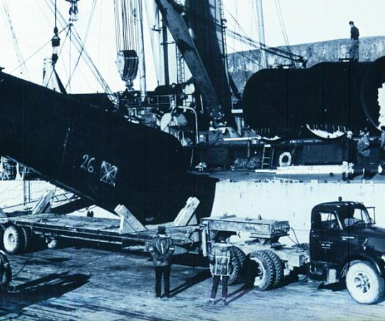 Following a deadly accident involving a bomb-laden B-52, crews at Greenland's Thule Air Base load cylinders of irradiated snow onto a U.S.-bound ship.
