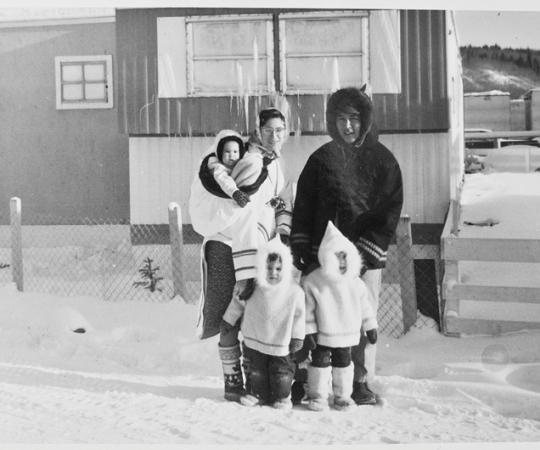 The Tootoos' 1965 Christmas portrait, with baby Victor in the author's amauti, Jennifer, the oldest, in front of her father, and in the middle, a restless Hunter. Photo Courtesy Sally Luttmer
