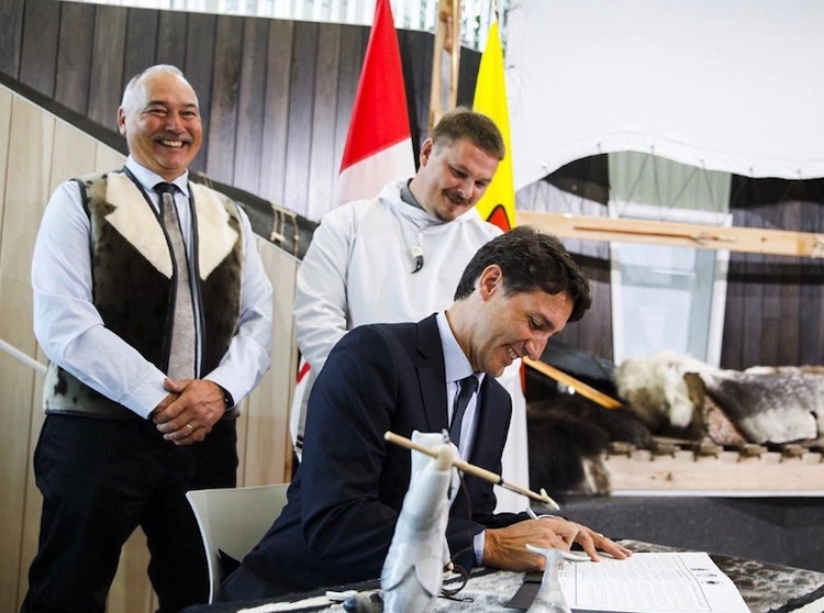Justin Trudeau signs the agreement for Tuvaijuittuq's creation with Nunavut Premier Joe Savikataaq (left) and QIA president P. J. Akeeagok. COURTESY DFO